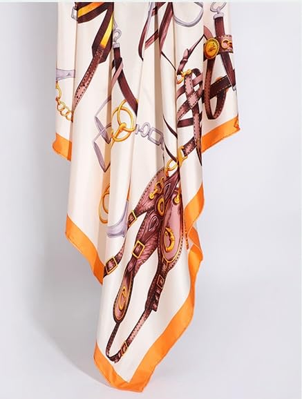 The tack print silk scarf hanging in soft folds showing the wide orange border
