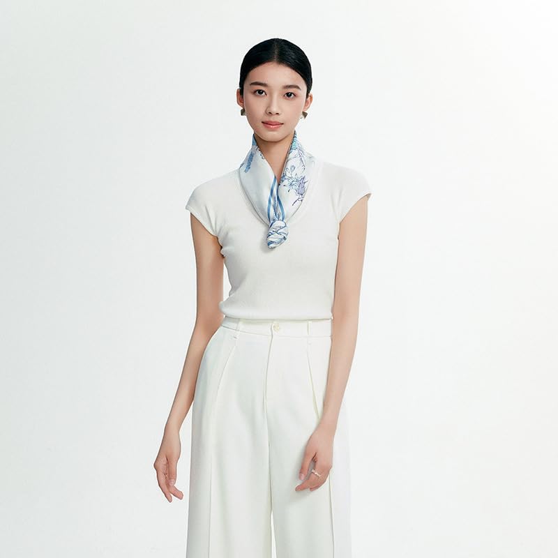 Model in white knitwear with the pale blue botanical silk scarf folded narrow at the neck