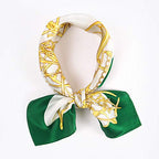 Ivory and gold bridle square coiled into a loop and tied in a small bow, green corners
