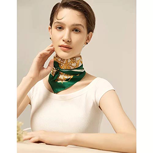 Woman at a table, gold-chain print square tied close at the neck, green border showing