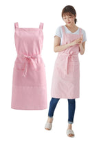 Soft pink cotton twill apron shown flat beside a woman wearing the same apron