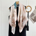 The ink wash lotus silk scarf hanging open beside a black dress