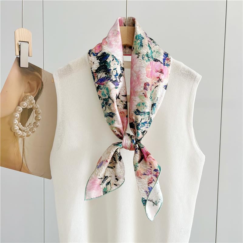 The painterly rose silk scarf knotted at the neck of a white display form