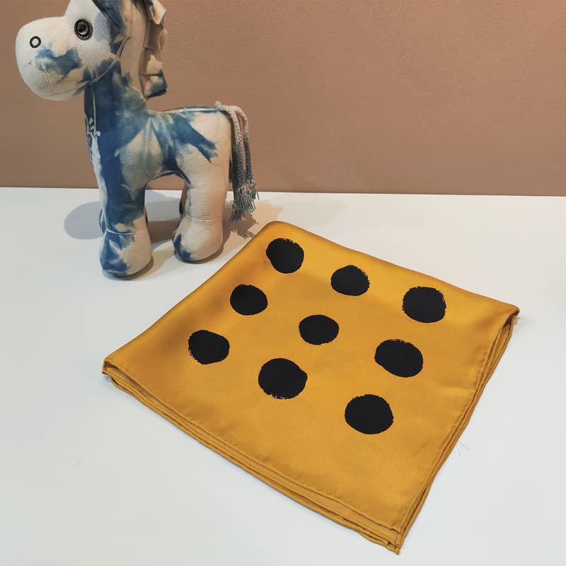 Golden yellow square folded to show nine brushed black dots, beside a small plush horse