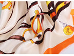 Close up of the chestnut and gold bridle and buckle print on cream silk