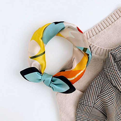Portrait square knotted into a loop beside a beige knit and checked trousers