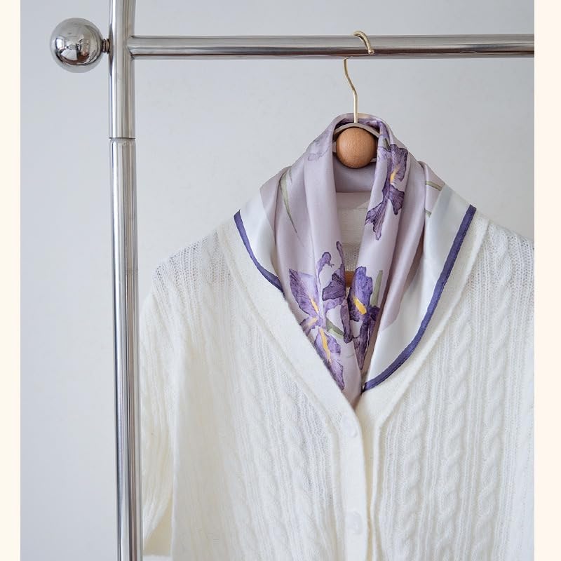 Iris square folded to a triangle over a white cardigan on a hanger, violet edge
