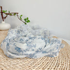 Close view of the blue botanical print on woven flax