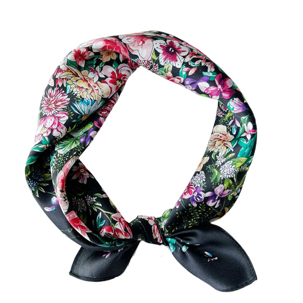 Black floral square coiled into a neck loop and tied, pink blooms massed all over