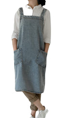 Woman in the pale washed denim pinafore apron carrying a canvas