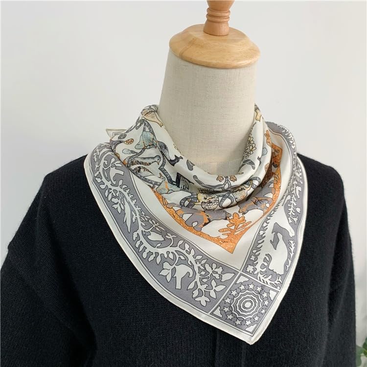 Cream animal square knotted at a dress form's neck over a black knit