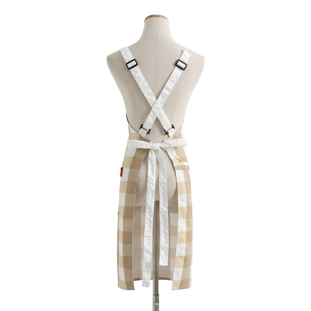 Back of a check apron on a dress form with the straps crossed behind the shoulders
