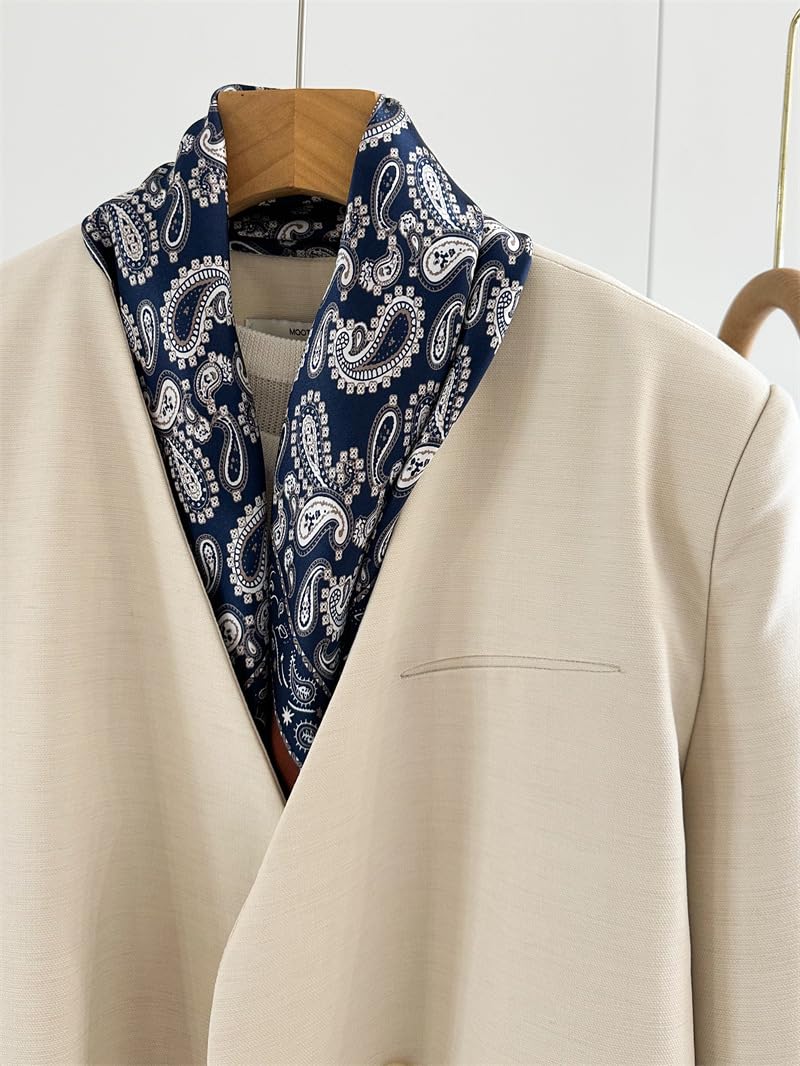Navy paisley square folded into a wide shawl collar over a cream jacket