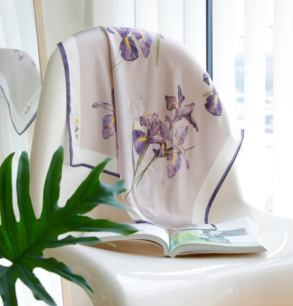 Iris square draped over a white ledge by a window, monstera leaf in front