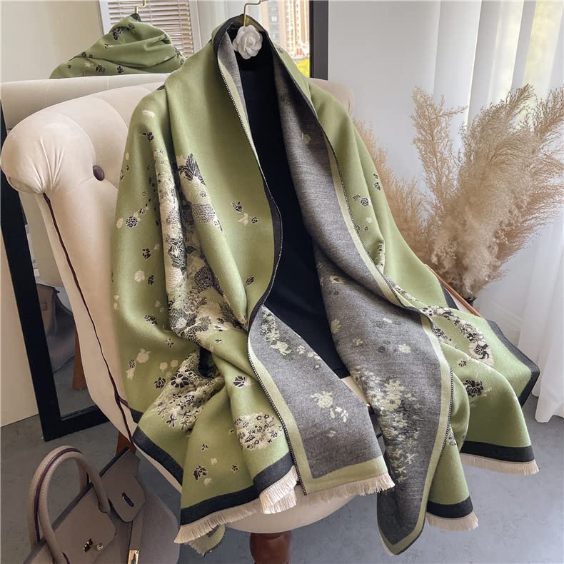 The sage shawl draped over an armchair beside a handbag showing the full spread of the floral print