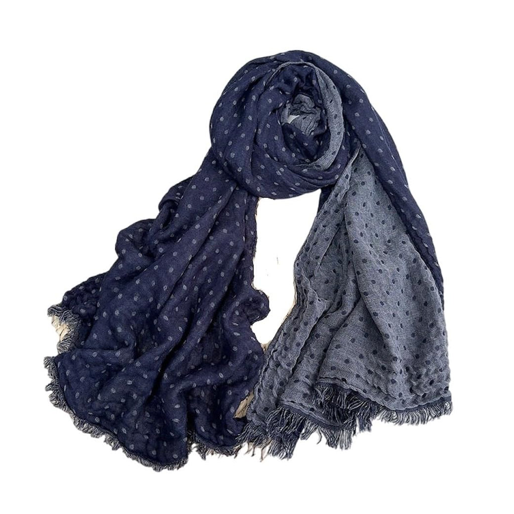 Jeelow ink blue polka dot scarf on a plain background, navy with grey dots on one half and grey with navy dots on the other, crinkled with frayed fringe