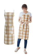 Woman in a large brown buffalo check cross back apron beside the same apron flat