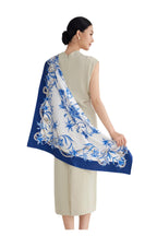 Blue and white silk scarf printed with daylily sprays pearls and butterflies inside a cobalt border