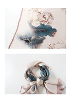 Two views of the ink lotus silk scarf folded and tied