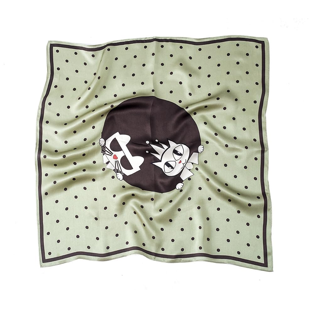 Sage green silk square with black dots and a dark medallion holding two cartoon cats