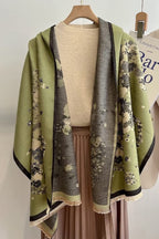 The shawl worn open over a dress form and a pleated skirt showing both printed panels hanging long