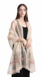 Model wearing the champagne beaded shawl open over a black dress