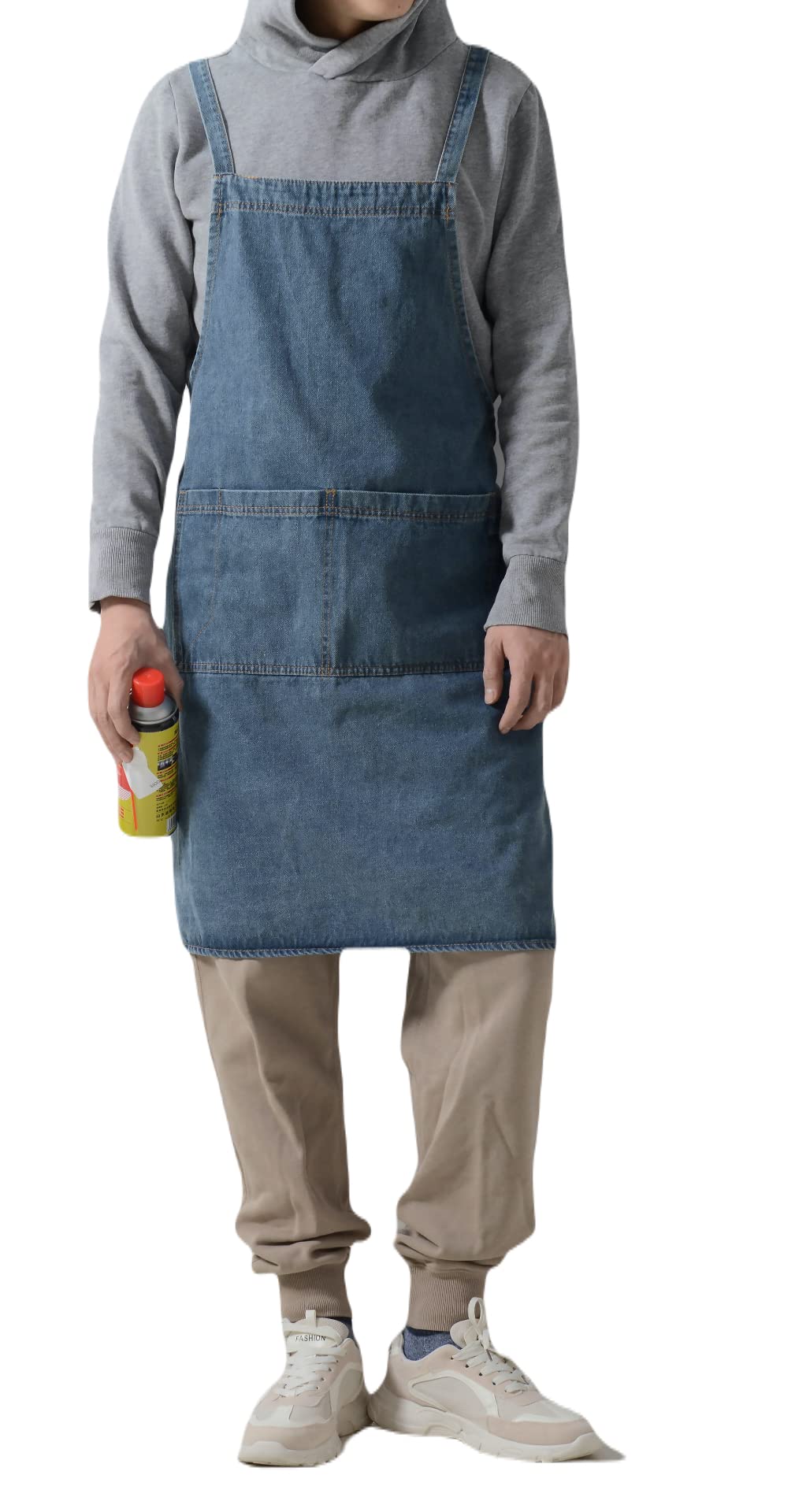 Woman in a mid blue washed denim cross back apron holding a bottle