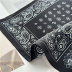 Folded black square showing the teardrop centre field beside the paisley border