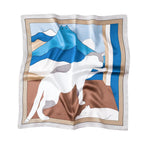 Silk square printed with blue mountains drawn as a cat face and a white cat lying below