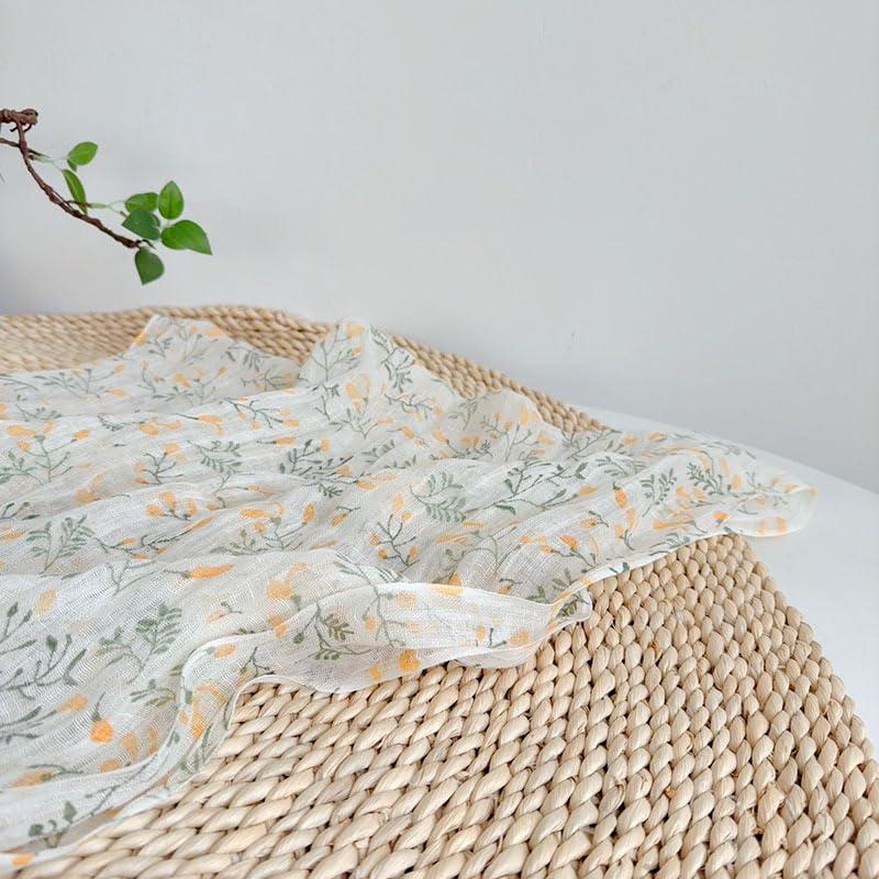 Yellow botanical linen scarf worn doubled at the neck
