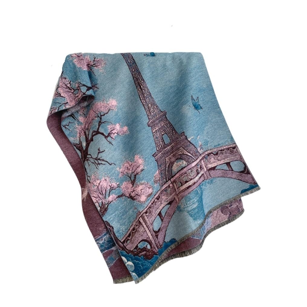Eiffel Tower and pink blossom shawl folded on white showing the dusk blue sky and plum border