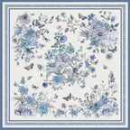 Flat view of the pale blue botanical silk scarf showing butterflies dragonflies and the slim blue rule border