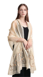 Khaki gold semi sheer shawl with trailing vine embroidery worn draped over a black dress