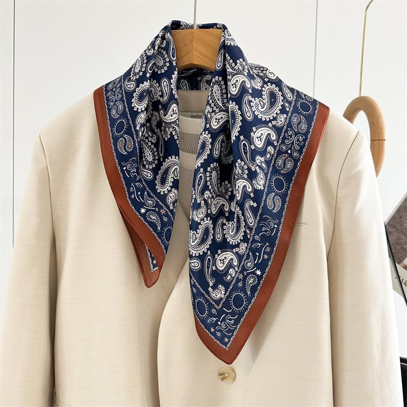 Navy paisley square draped open over a cream blazer, rust border tracing the neckline