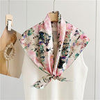 The painted floral silk scarf tied loosely showing the visible brushwork