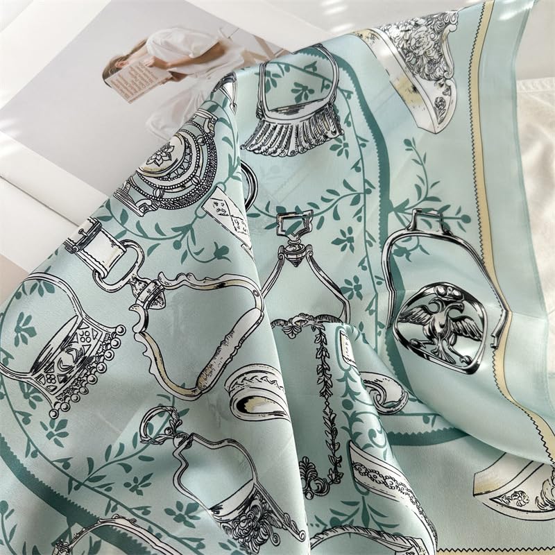 Aqua square falling in soft folds, green vine scrolls and the gold edge line visible
