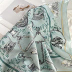 Aqua square falling in soft folds, green vine scrolls and the gold edge line visible