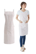Woman wearing a soft pink windowpane check cross back apron