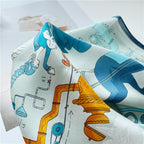 Close-up of a copper tea urn and blue figures printed on rippled pale blue silk