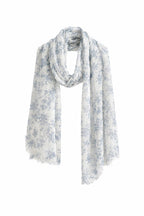 Pure linen scarf printed with a soft blue botanical motif, frayed edge