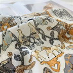 Close-up of gold and grey birds, horses and a fox drawn among flowering vines