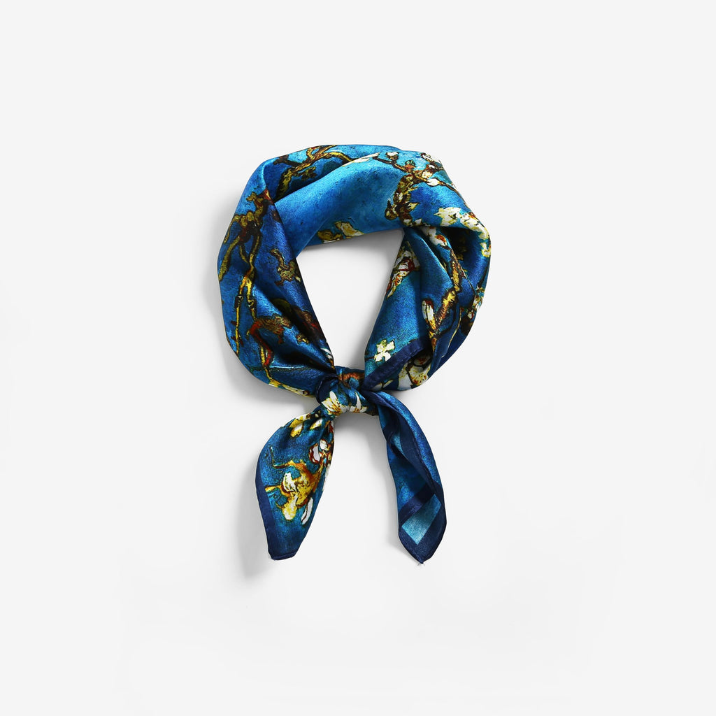 Almond-blossom square coiled into a ring and tied in a flat knot on grey