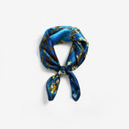 Almond-blossom square coiled into a ring and tied in a flat knot on grey