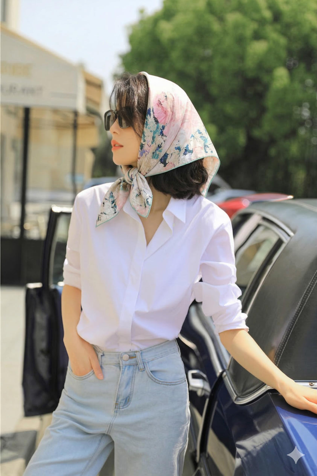 Street style shot of the painted rose silk scarf worn as a headscarf