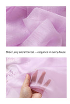 Lavender fabric close up and a hand held behind the sheer ground