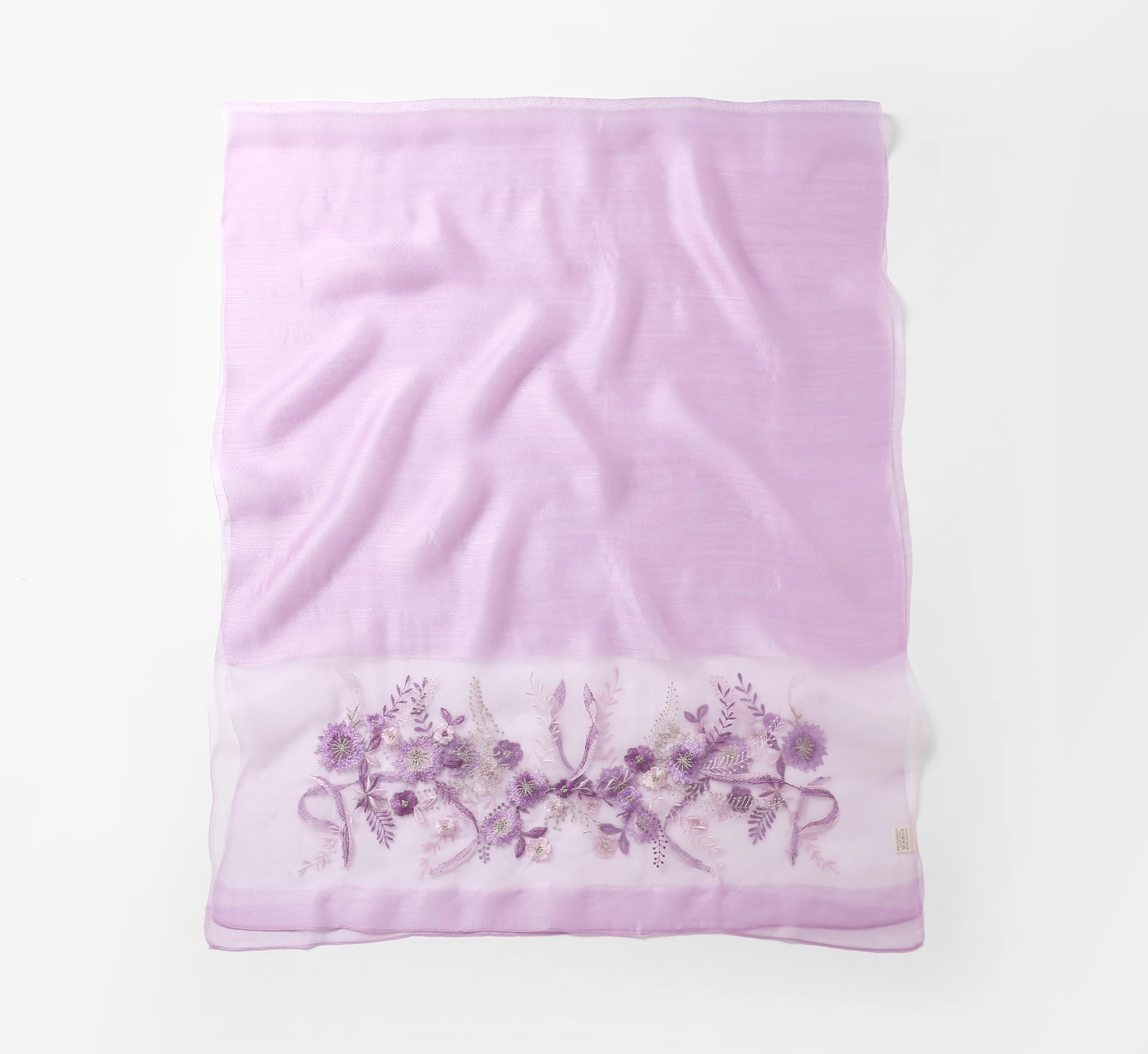 Lavender shawl folded flat showing full width with the embroidered band along the bottom edge