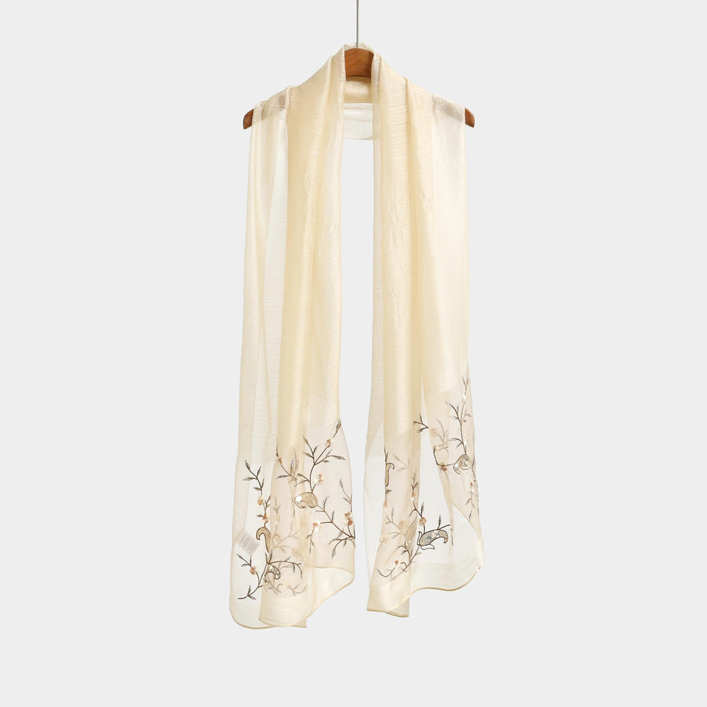 Khaki shawl hung straight showing full length and the vine pattern