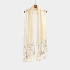 Khaki shawl hung straight showing full length and the vine pattern
