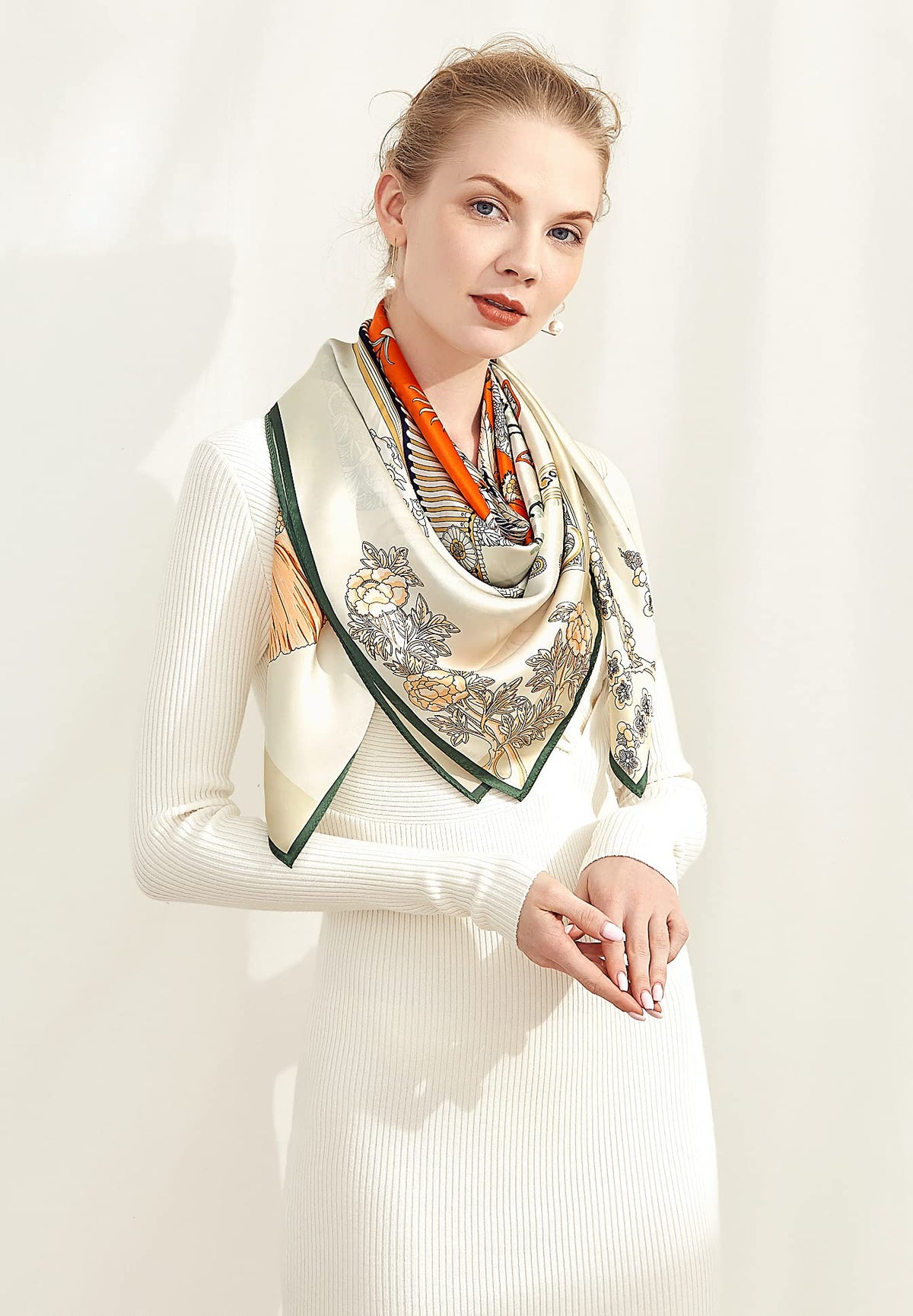 Model in white knit with the ivory and orange engraved print silk scarf