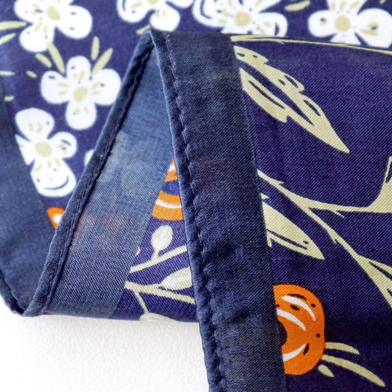 Corner detail, the navy rolled hem turning back over the white blossom print